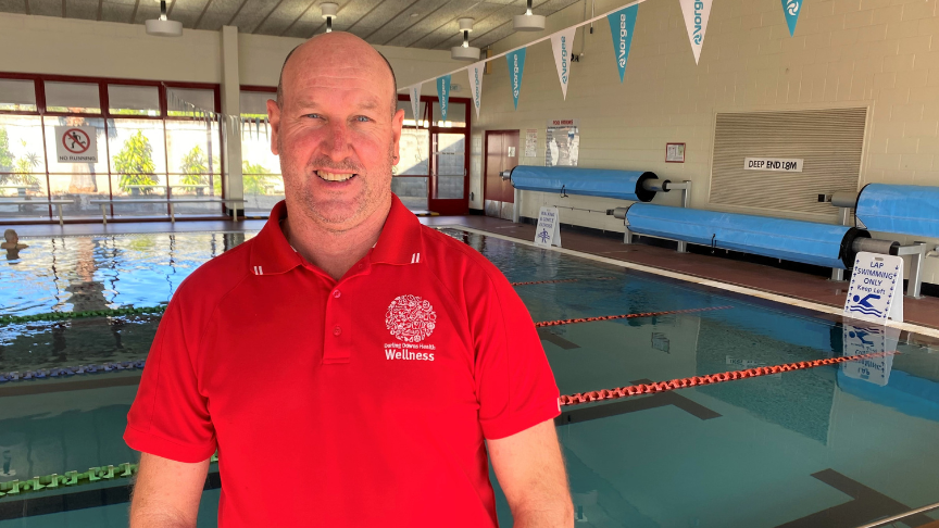 Micheal Wise standing in front of the Aquatic Centre