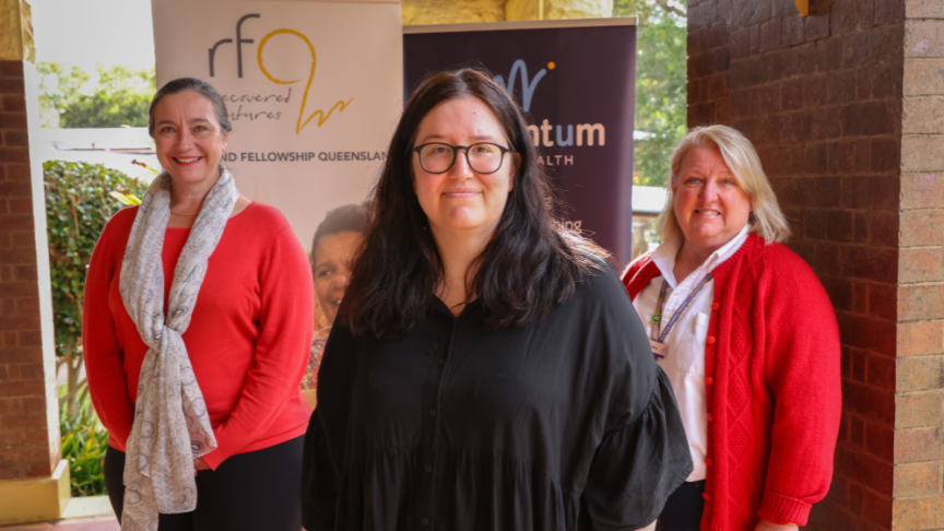 Debbie Bailey, Laura Lattanzio, Marea Webb standing in front of pull up banners