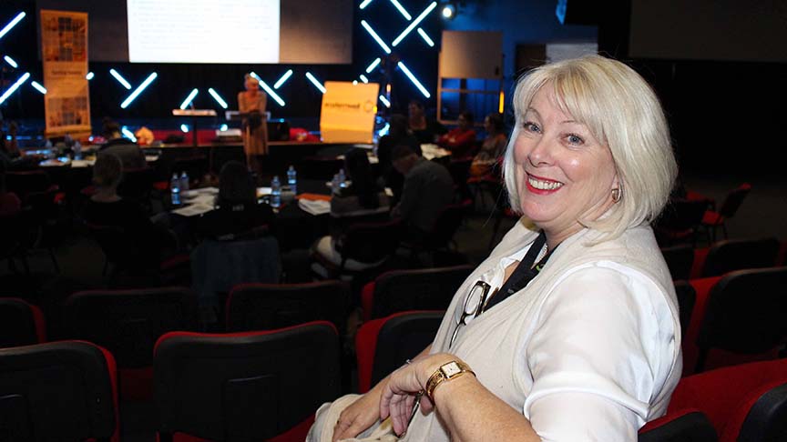 Photo of staff member Kerry McNally turning in her seat and smiling