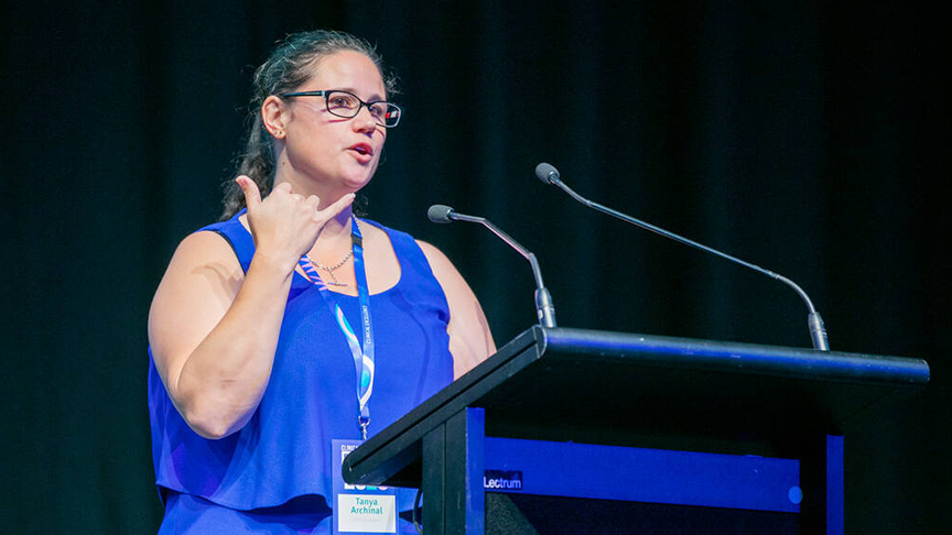 A woman speaking at a podium