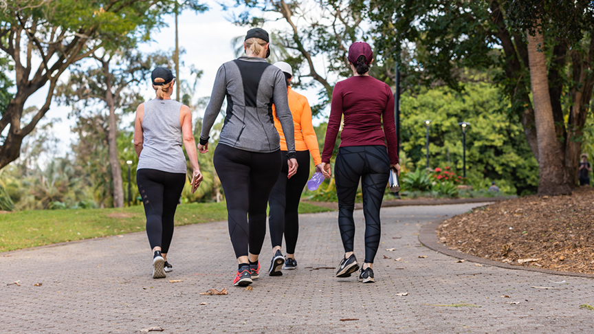 Four women walking in a park