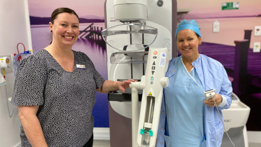 Two woman standing at the contrast enhanced mammogram machine at Toowoomba Hospital